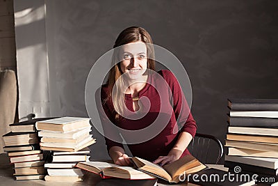 Girl reading a book in the library is preparing for the exam Stock Photo