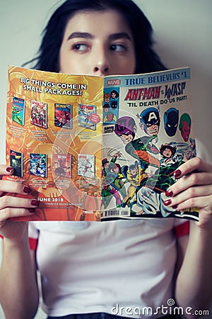 Girl reading comics Editorial Stock Photo