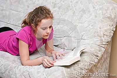 Girl reading on sofa Stock Photo