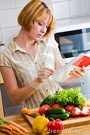 Girl reads a cookbook Stock Photo