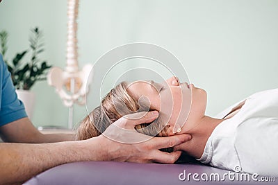 A girl receiving CST treatment. Osteopathic Manipulation and CranioSacral Therapy for children and adults Stock Photo