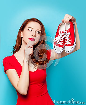 Girl in red dress with gumshoes Stock Photo