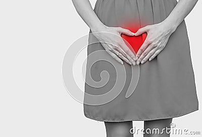 Girl in the red dress pressed her hands to the stomach, heart gesture, love. Women`s health, sexuality Stock Photo