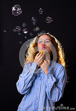 Girl with red hair blow bubbles Stock Photo