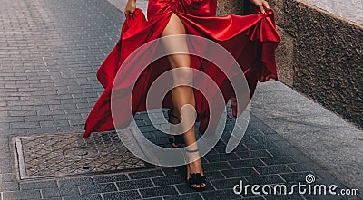 The girl in the red. Long, slender legs Stock Photo