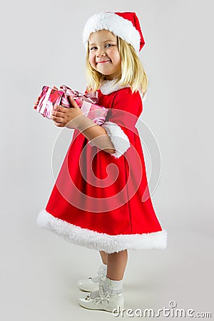 Girl in red new year cap with a celebratory gift Stock Photo