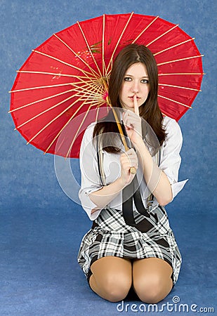 Girl with red oriental umbrella on blue Stock Photo