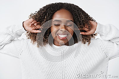 Girl refuse listen close earholes with index fingers and feeling happy, upbeat with shut eyes, smiling broadly and Stock Photo