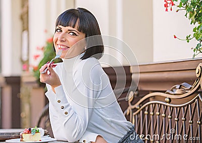 Girl relax cafe with cake dessert. Excellent taste. Woman attractive elegant brunette eat gourmet cake cafe terrace Stock Photo