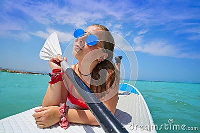 Girl relaxed lying on paddle surf board SUP Stock Photo