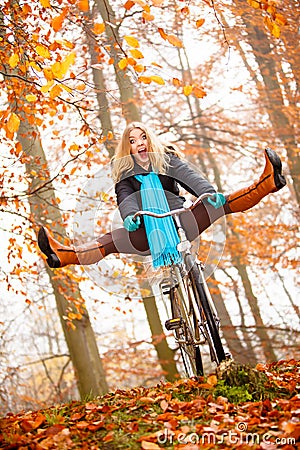 Girl relaxing in autumnal park with bicycle Stock Photo