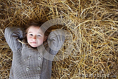 Girl relaxing on hay and thinking Stock Photo