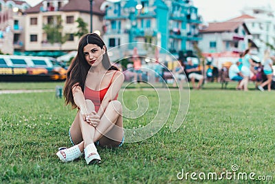 Girl relaxing on the lawn in a city park Stock Photo