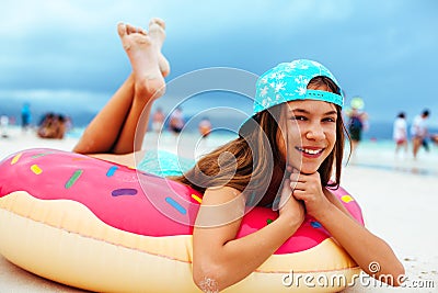 Girl relaxing with lilo on the beach Stock Photo