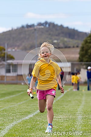 Girl in relay race Stock Photo