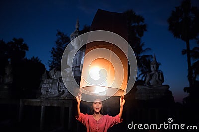 The girl is releasing the lamp. Thailand culture in rural Stock Photo