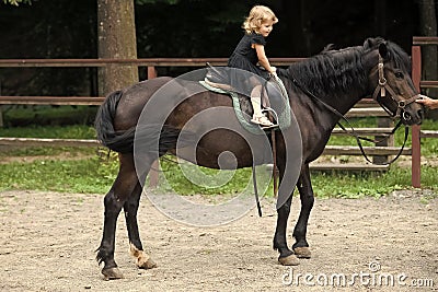 Girl ride on horse on summer day Stock Photo