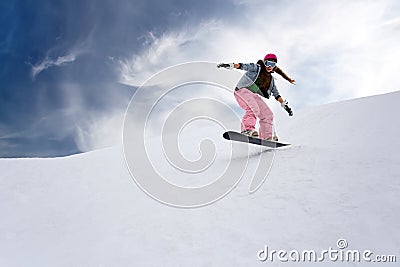Girl rider jump on snowboard Stock Photo