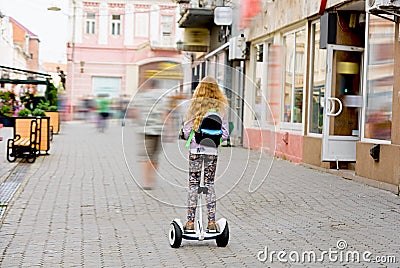 A girl rides across the road on Gyroscooter.Post processing Editorial Stock Photo