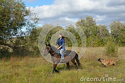 Girl rides, dog Stock Photo