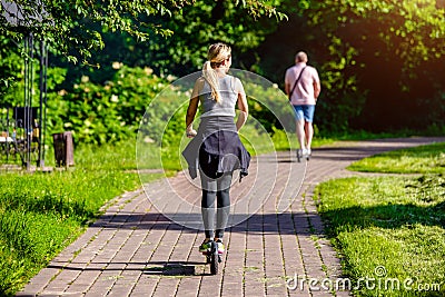 Girl rides an electric scooter Editorial Stock Photo