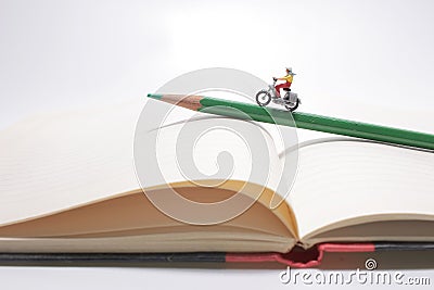 A Girl rides on a motorcycle over open diary book. Travel concept Stock Photo