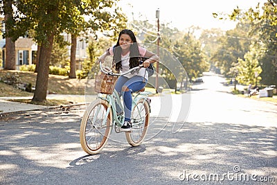 Girl Riding Bike Along Street To School Stock Photo