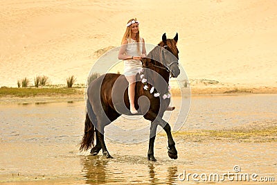 Girl riding her stunning Frisian horse Stock Photo