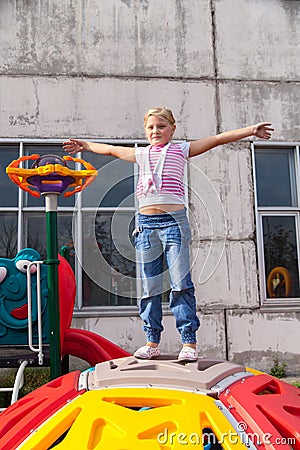 Girl riding rides on a child playground Stock Photo