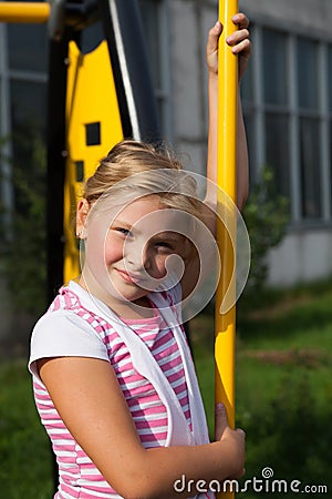 Girl riding rides on a child playground Stock Photo