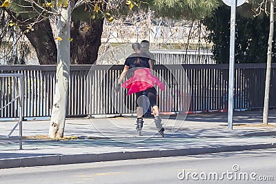 Girl rollerblading in the city, using bike lane in Seville, Spain Editorial Stock Photo