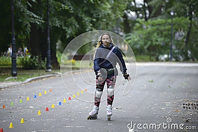 Girl rollerblading in a park Editorial Stock Photo