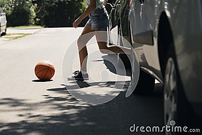 Girl running with ball on pedestrian crossing Stock Photo