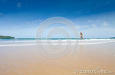 Girl running on beach Stock Photo
