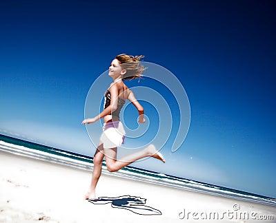Girl running down the beach Stock Photo