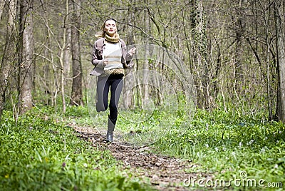 Girl running in forest Stock Photo