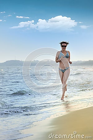 The girl running on seacoast Stock Photo