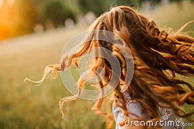 Girl runs hair curls develop glow sun Stock Photo