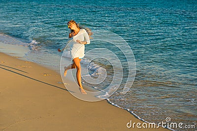 Girl runs along the seashore Stock Photo