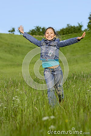 Girl runs on a grass Stock Photo