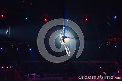 Girl`s aerial acrobatics in the Circus arena. Stock Photo