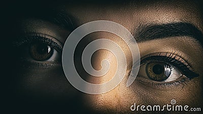 Girl`s eyes close portrait of horror from the shadows Stock Photo