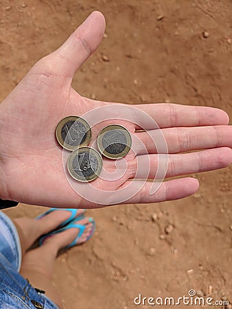 Girl`s hand with three euros in Cyprus Stock Photo