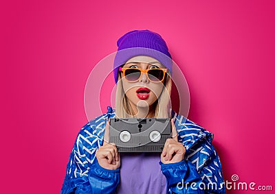 Girl in 90s sports jacket and VHS cassette Stock Photo