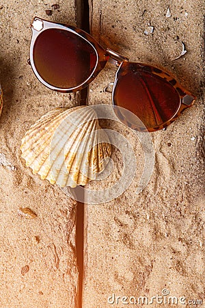 Girl's sunglasses and seashell. Stock Photo