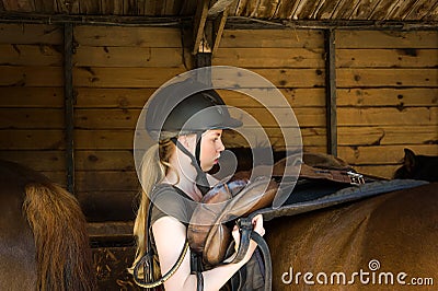 Girl saddle a horse Stock Photo