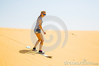 Girl sand boarding Stock Photo