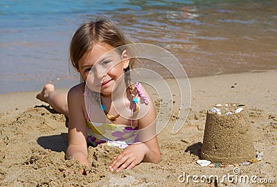 Girl with sandcastle Stock Photo