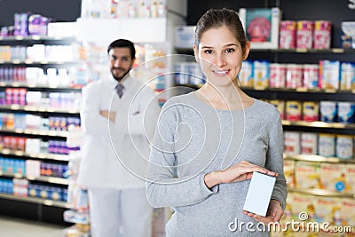 girl is satisfied the purchase in pharmacy. Stock Photo