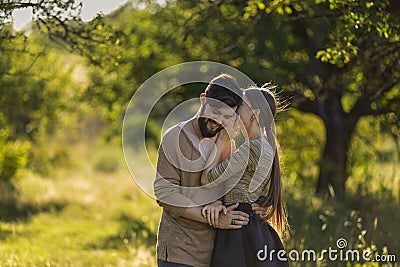 girl says something in the ear of her boyfriend Stock Photo